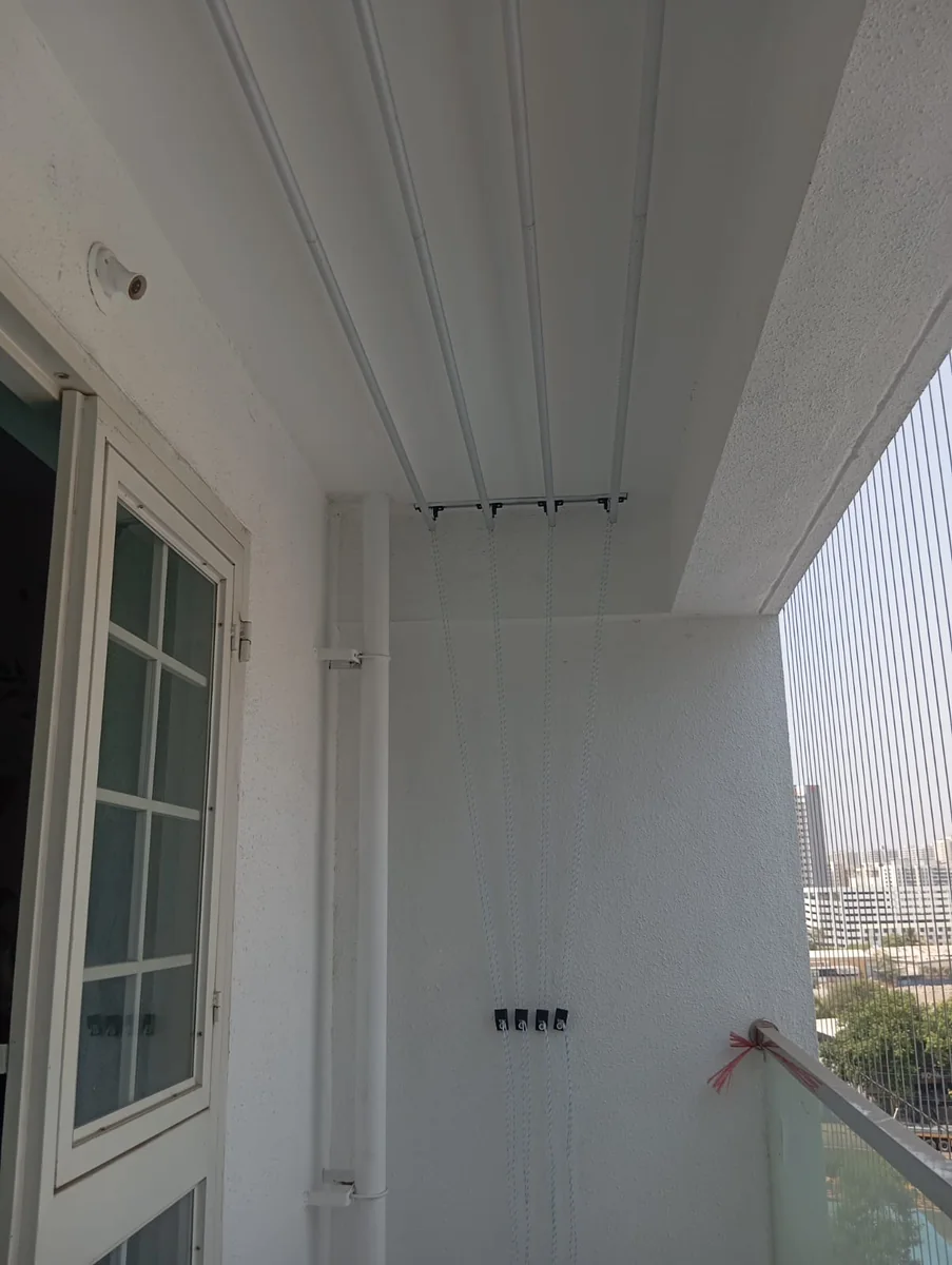 Side view of ceiling mounted drying hanger with ropes