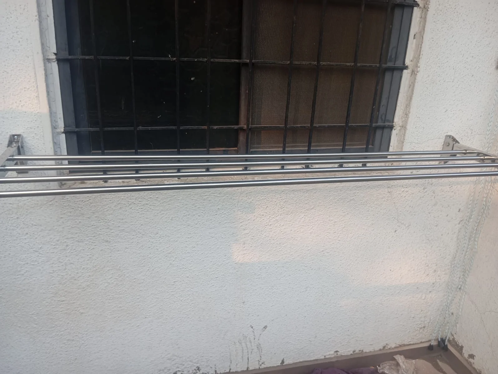 Wall mounted aluminium hanger below window